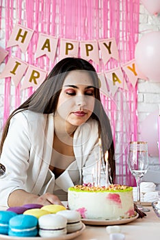 Woman in white party clothes preparing birthday table