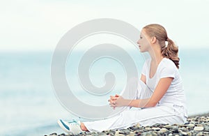 Woman in white relax resting on the sea on the beach