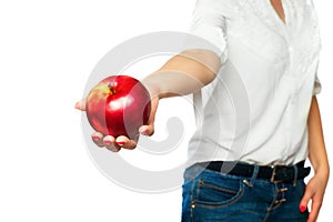 A woman in a white shirt holds an apple in her hand.