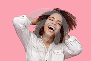 Woman in white shirt long sleeve laughing opening her mouth.