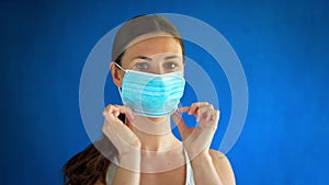 Woman in white shirt shows how to wear a mask during a pandemic