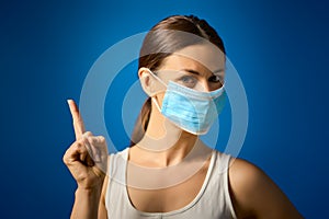 Woman in white shirt shows how to wear a mask during a pandemic