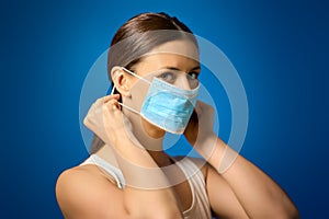 Woman in white shirt shows how to wear a mask during a pandemic