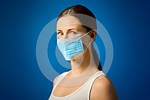 Woman in white shirt shows how to wear a mask during a pandemic