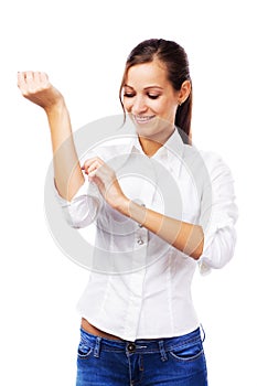 Woman in white shirt turning up sleeves