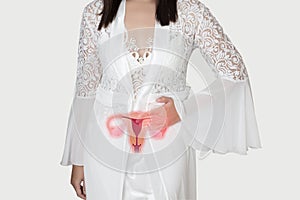 Woman in white silk nightgown and lace robe with uterus pain at night. People having belly ache.