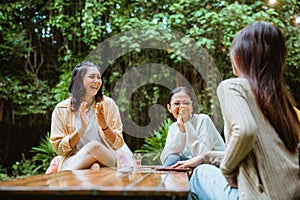 woman in white t shirt clap her hands and laughing