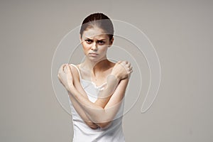 woman white t-shirt touching her shoulders with hands cropped view close-up