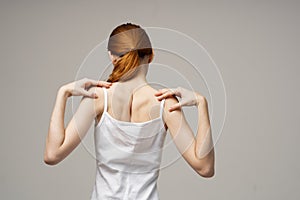 woman white t-shirt touching her shoulders with hands cropped view close-up