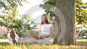 Woman in white t shirt working on laptop pc computer
