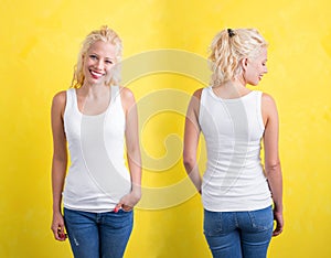 Woman in white tanktop on yellow background