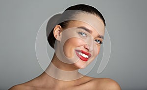 Woman with White Teeth and Red Lips Smiling to Camera