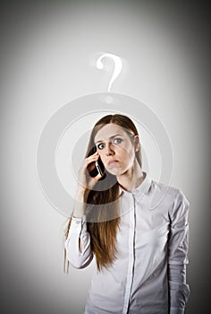 Woman in white with telephone. Question concept.