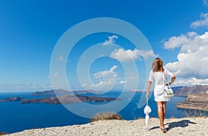 Woman with white umbrella and sea