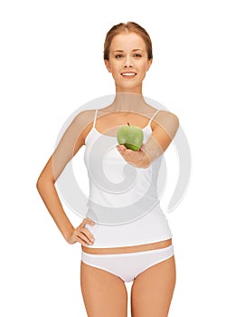 Woman in white underwear holding green apple