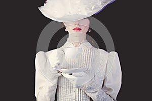 Woman in white Victorian era clothes with cup of tea