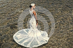 Woman in white wedding dress. Female fashion, beauty and advertisement concept. Bride on sunny summer day on seascape