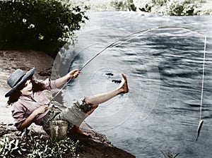 Woman who caught a small fish falling over backwards