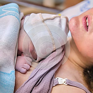 A woman who gave birth to a newborn baby boy. Laying the child out on the mother chest immediately after childbirth