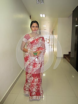 Woman who is looking very beautiful standing in hotel wearing indian shari