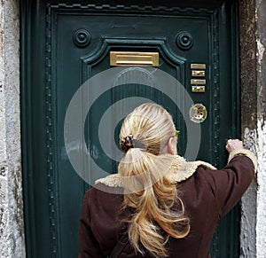 Woman who opens her home door. Venice, Italy - people