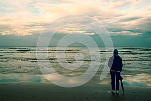 A woman who is watching the waves in the sea