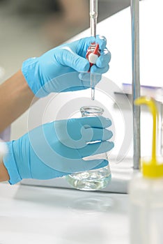 The woman whoâ€™s the scientist is demonstrate the titration technique