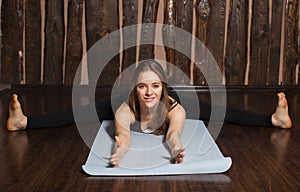 Woman is in Wide-angle seated Forward bend pose