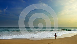 Woman on the wide beach of the ocean