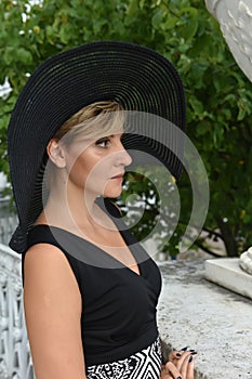 Woman in wide-brimmed hat and dress  portrait