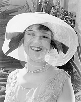 Woman in a wide brimmed hat smiling photo