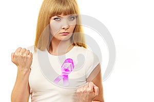 Woman wih pink cancer ribbon on chest punching
