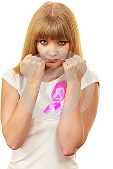 Woman wih pink cancer ribbon on chest punching