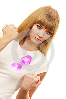 Woman wih pink cancer ribbon on chest punching