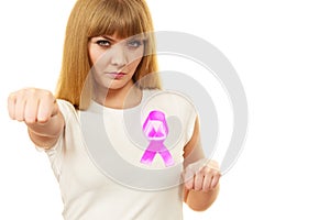 Woman wih pink cancer ribbon on chest punching