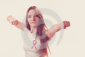 Woman wih pink ribbon on chest punching boxing