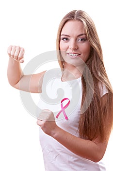 Woman wih pink ribbon on chest punching boxing