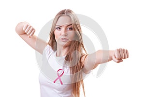 Woman wih pink ribbon on chest punching boxing