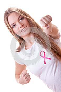 Woman wih pink ribbon on chest punching boxing