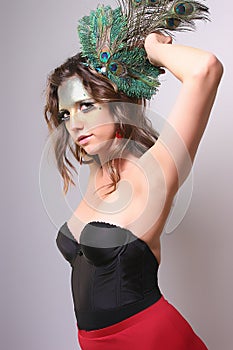 Woman with Wild Makeup with a Peacock Feather in her Hair
