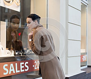Woman at window shop jewellery