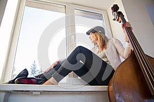 Woman on windowsill looking outdoor on street