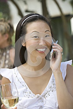 Woman With Wine Glass Using Cell Phone