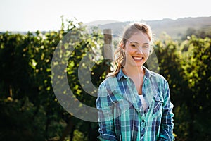 Woman winemaker with grapes in a vineyard