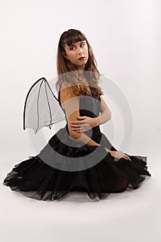 Woman wings black dress sitting