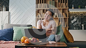 Woman winner rejoicing success looking on laptop at home. Girl feeling happy