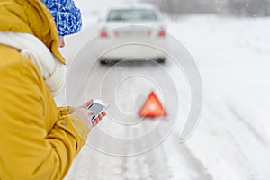 A woman in winter calls to the emergency services.