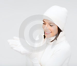 Woman in winter clothes with something on palms