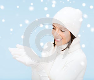Woman in winter clothes with something on palms