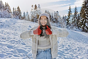 Woman in Winter Clothes Thumbs Up in Front of Mountain Forest Outdoors